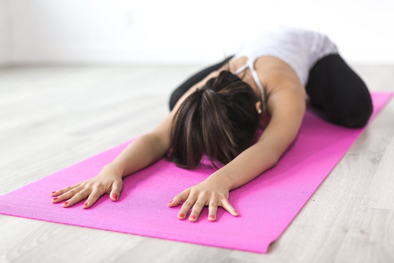 Woman practicing Forward Fold